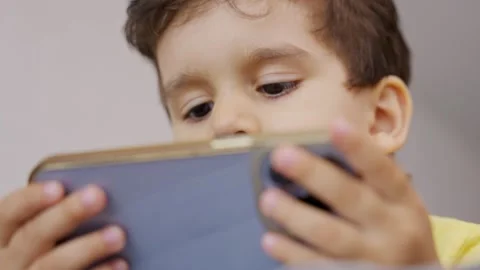 Cute little kid having fun using cellphone Stock Footage 246071505