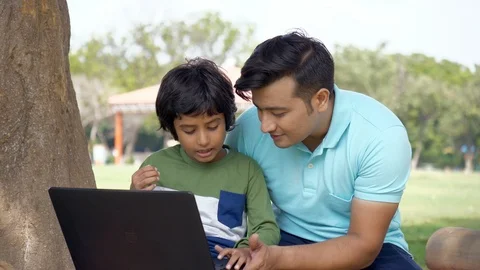Cute little kid learning how to work on a laptop from his dad - technology in... 스톡 동영상 118516100