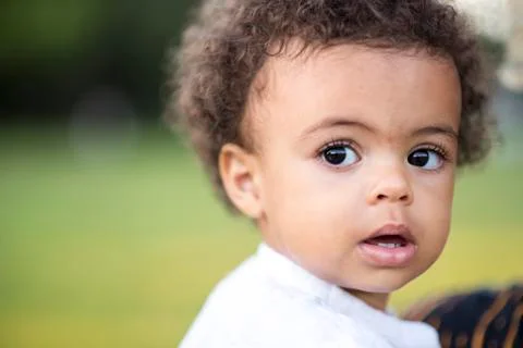 Cute little mixed race baby in the park Stock Photos