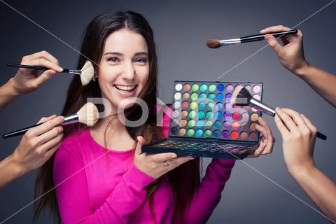 Cute make-up artist holding her vast palette of colors Stock Photos