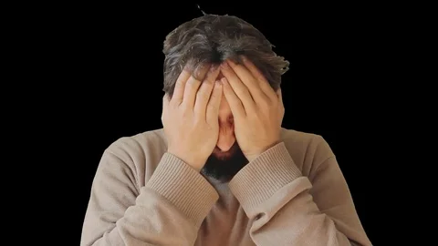 Cute man with a beard rubs his face with his hands Stock Footage 79342748
