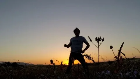 Cute man is dancing alone in the field Stock Footage 80962397