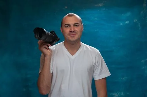 Cute man photographer posing with camera Stock Photos