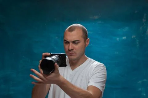 Cute man posing on blue background Stock Photos