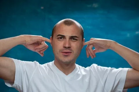Cute man posing on blue background Stock Photos
