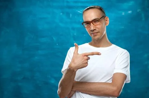 Cute man posing on blue background Stock Photos