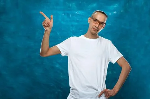 Cute man posing on blue background Stock Photos
