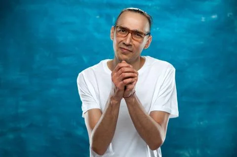 Cute man posing on blue background Stock Photos