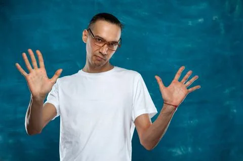 Cute man posing on blue background Stock Photos