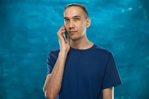 Cute man posing on blue background Stock Photos