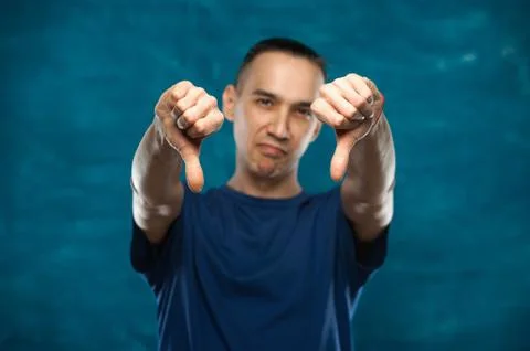 Cute man posing on blue background Stock Photos