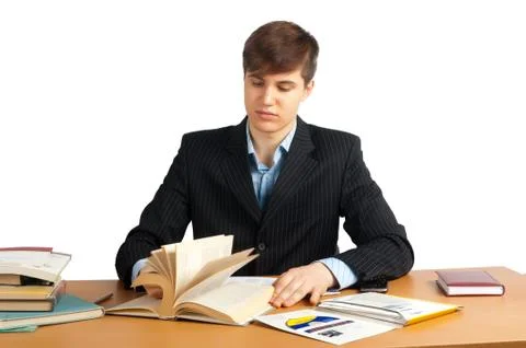 Cute man reading book at table Stock Photos