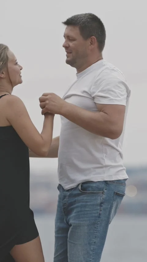 A cute married couple dancing on the pier Stock Footage 329217371