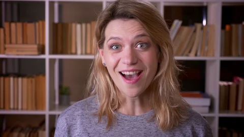 Cute middle-aged blonde teacher laughing into camera being extremely happy at Video stock 108400911