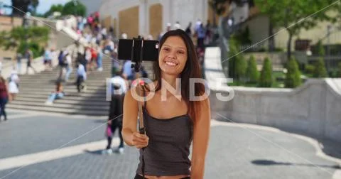 Cute millennial girl vacationing Rome taking silly selfies by the Spanish Ste Stock Photos