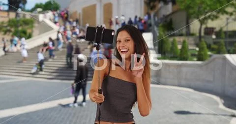 Cute millennial girl vacationing Rome taking silly selfies by the Spanish Ste Stock Photos
