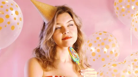 Cute model with colorful sweets on pink background Stock Footage 106348158