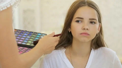 A cute model gets makeup put on before her shoot. Close up shot Stock Footage 67858840