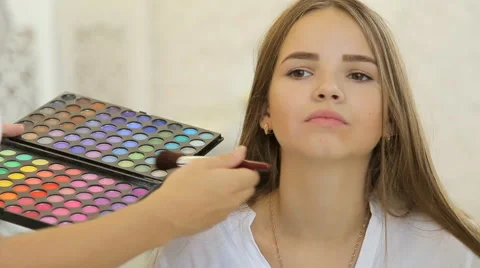 A cute model gets makeup put on before her shoot. Close up shot Stock Footage 67858888