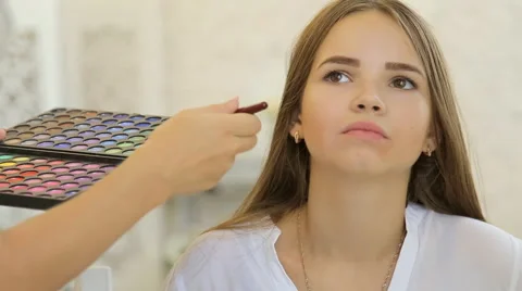 A cute model gets makeup put on before her shoot. Close up shot Stock Footage 67858950