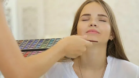 A cute model gets makeup put on before her shoot. Close up shot Stock Footage 67858999
