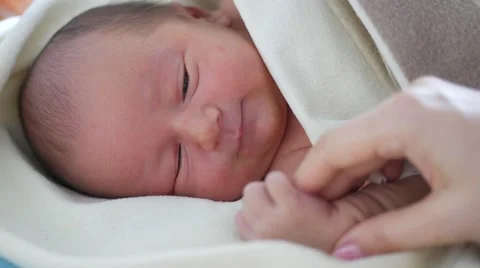 Cute newborn looking around himself and to the mother's hand Stock Footage 67209922