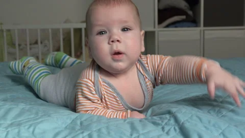 Cute newborn lying on the bed and smiling to the camera  Stock Footage 93268798