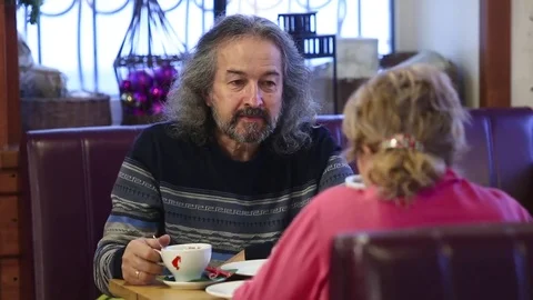 Cute old couple drinking coffee in cafe and talk Stock Footage 83869595