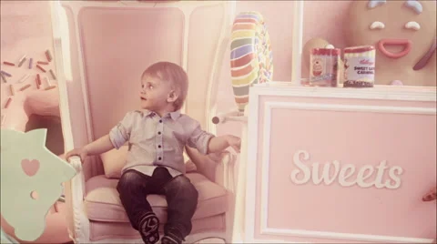 Cute one year old baby sitting on the ottoman in the nursery. Stock Footage 67435227