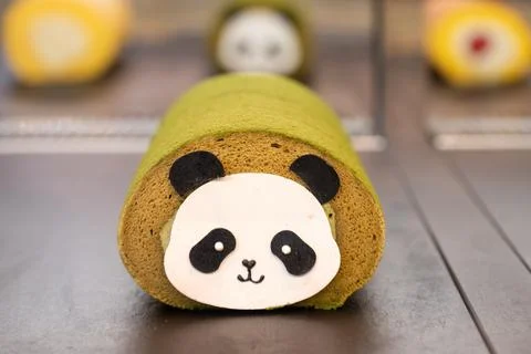 Cute Panda Roll Cake With Matcha Sponge and Cream Filling on Display Stock Photos