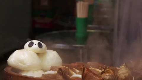 Cute panda steam bun in steamer with sticky rice wrapped in leaves Stock Footage 326026253