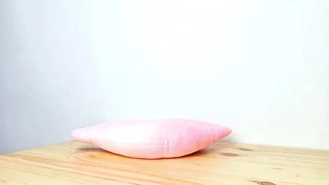 Cute Plush Rabbit Toy on Pink Cushion with Hand Stock Footage 287798312