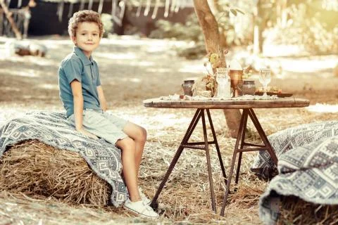 Cute positive boy sitting at the table Foto stock