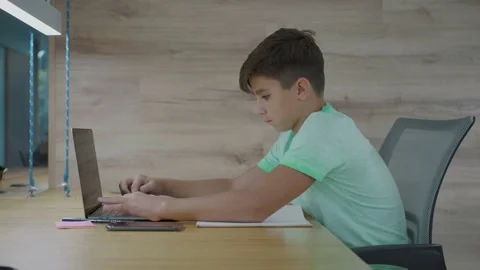 Cute pre teen boy using laptop for homework and remote school education 스톡 동영상 142862066