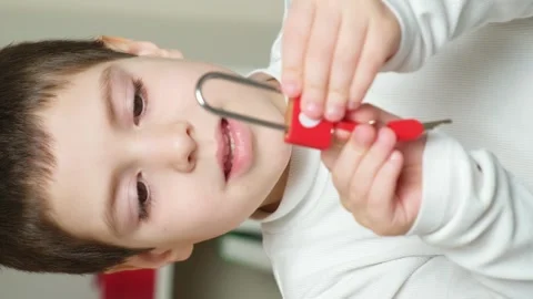 Cute preschool boy opens a red lock with heart keys. Children's Valentine's Day 스톡 동영상 241602638