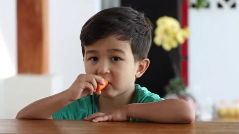 Cute preschool kid boy eats fresh carrot. Healthy snack. Stock Footage 159486939