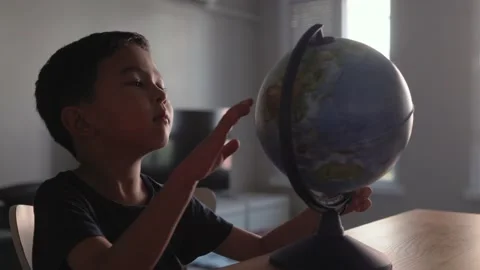 Cute Preschooler explores countries on the globe Stock Footage 204071847