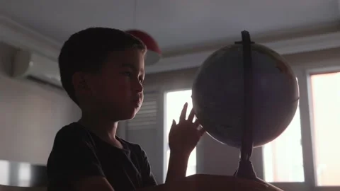 Cute Preschooler explores countries on the globe Stock Footage 204071978