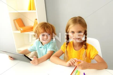 Cute preschoolers studying indoors Stock Photos