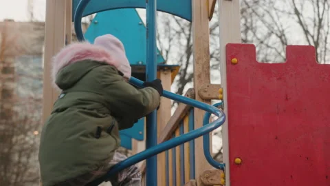Cute pretty child rides on balancing swing. Little girl laughing and having fun Stock Footage 237989097