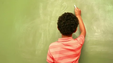 Cute pupil writing maths on chalkboard Stock Footage 45382135