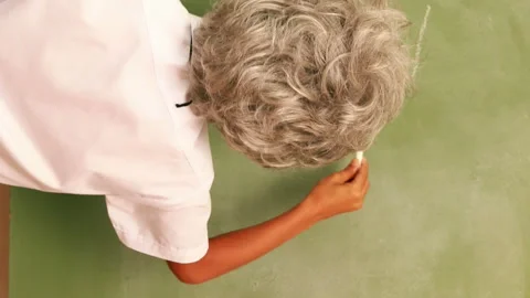 Cute pupil writing maths on chalkboard Stock Footage 302139508