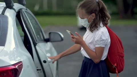 Cute pupils using smartphones at the elementary school. Boy and girl in safety Stock Footage 136102290
