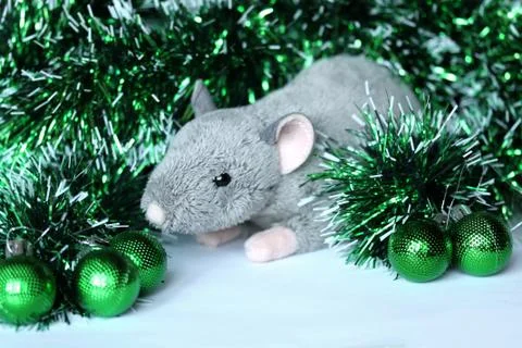 Cute rat or mouse soft toy with green ornaments and tinsel Stock Photos