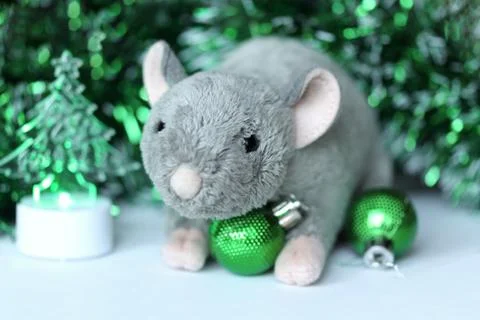 Cute rat or mouse soft toy with green ornaments and tinsel Stock Photos