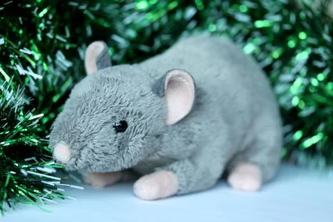 Cute rat or mouse soft toy with green tinsel Stock Photos