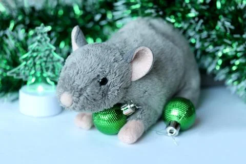 Cute rat or mouse soft toy with green ornaments and tinsel Stock Photos