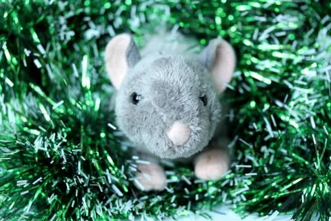 Cute rat or mouse soft toy with green tinsel Stock Photos