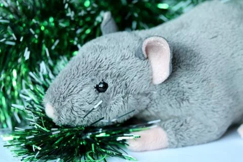Cute rat or mouse soft toy with green tinsel Stock Photos