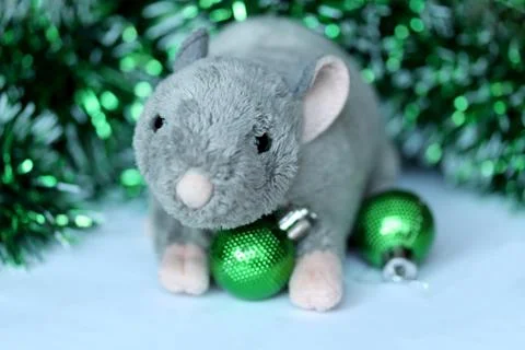 Cute rat or mouse soft toy with green ornaments and tinsel Stock Photos